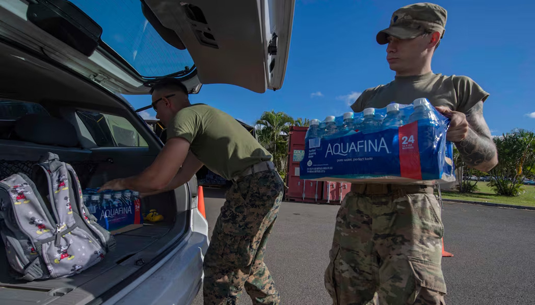 Service members help distribute water at Joint Base Pearl Harbor-Hickam, Hawaii, in February 2022, to families whose water was contaminated by the fuel spill in Hawaii. (Seaman Chris Thomas/U.S. Navy)